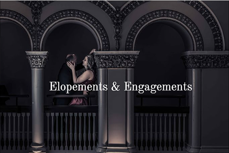 Photograph of a couple embraces on a balcony with ornate arches in a dimly lit setting.