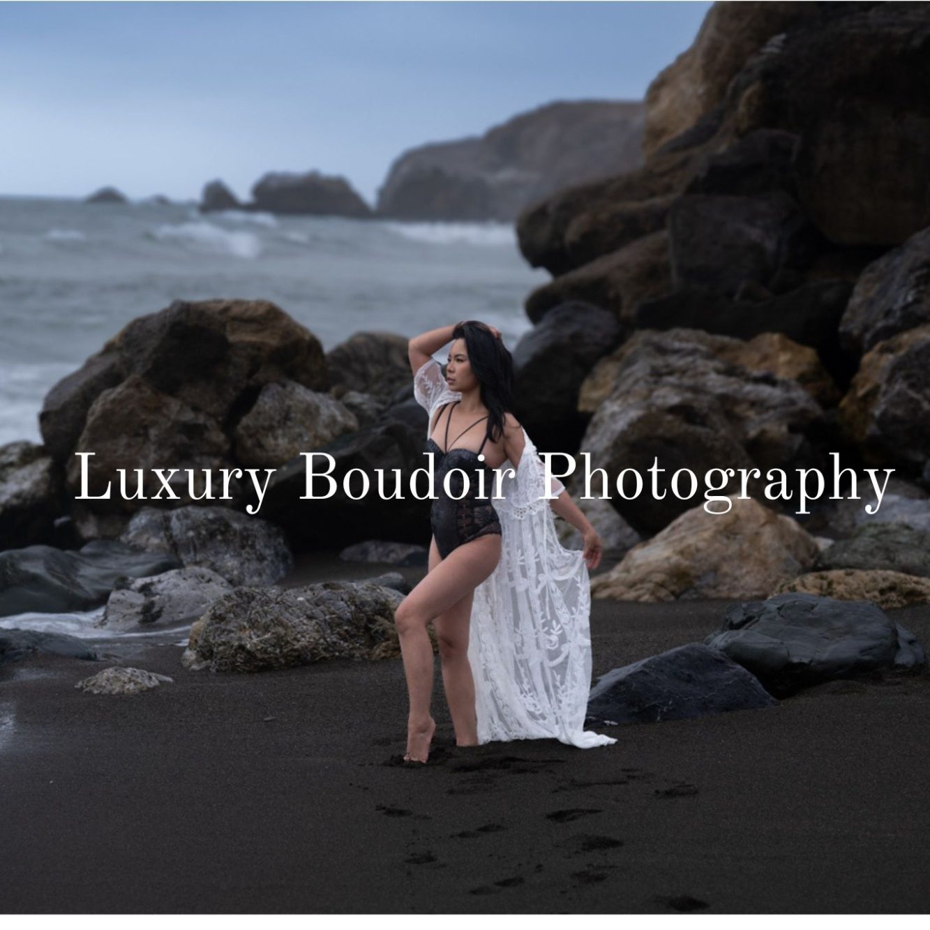 Luxury boudoir portrait of a woman on a dramatic coastal landscape, celebrating confidence and artistry by Silent J Fine Art.